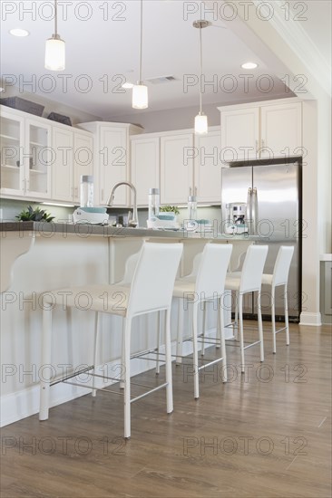 Row of bar stools at kitchen island