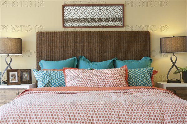 Blue and pink pillows arranged on bed