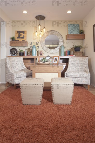 Chairs and footstools in seating area of house