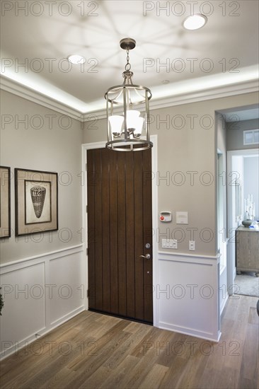 Lit light fixture hanging in domestic room