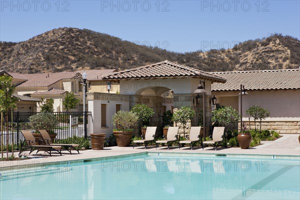 Outdoor swimming pool and deck chairs at community center