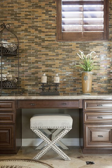 White seat at study table against tiled wall