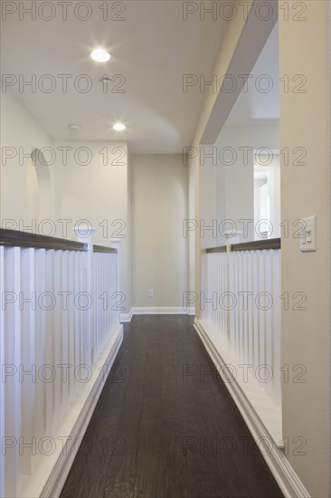 Straight hallway with white railings