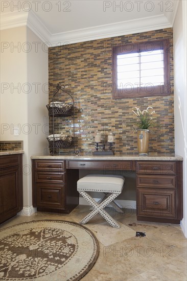 Stool at sideboard in domestic bathroom