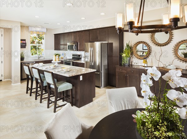 View of domestic kitchen through dining area