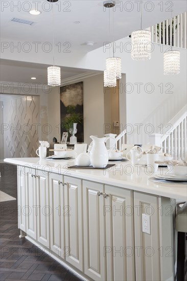 Crockery on counter top below pendant lights at home