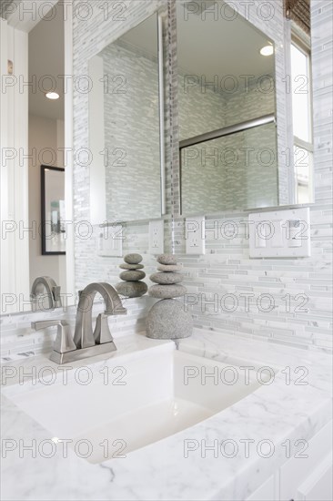 Contemporary bathroom with marble washbasin and mirror at home
