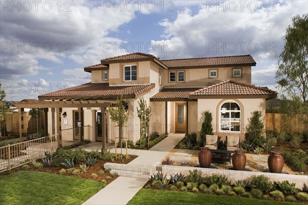 Walkway leading to front entrance of traditional home