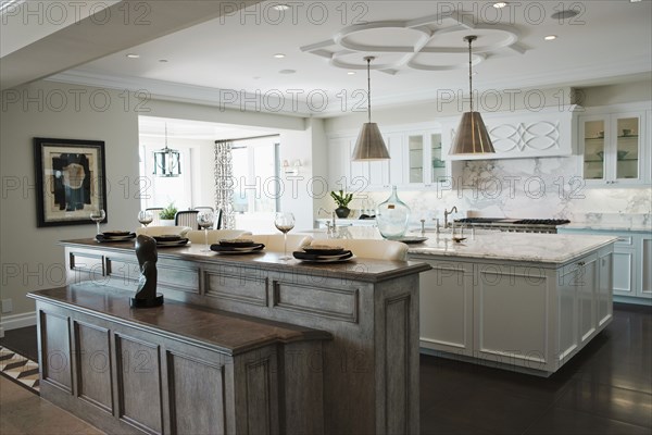Place settings at breakfast bar in contemporary kitchen