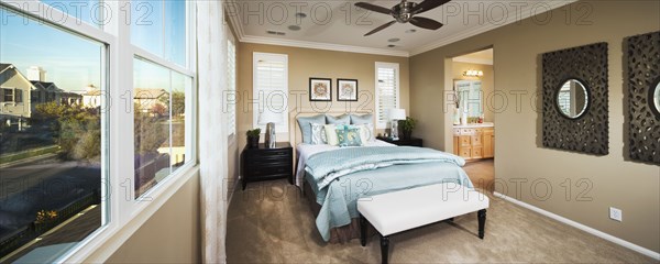 Light blue bed in master bedroom