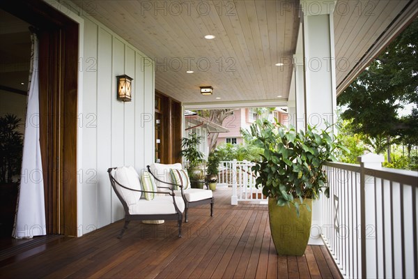 Two chairs on front porch of Hawaiian home