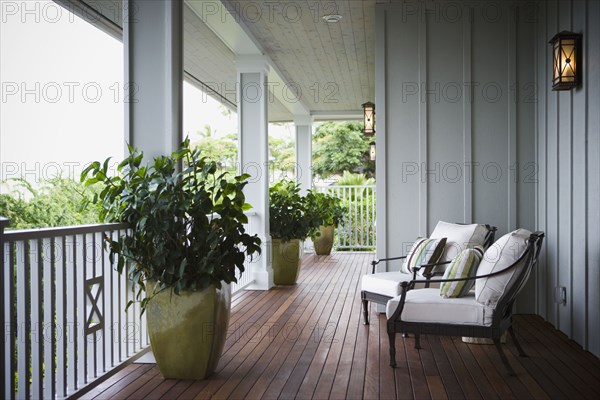 Two chairs on front porch of Hawaiian home