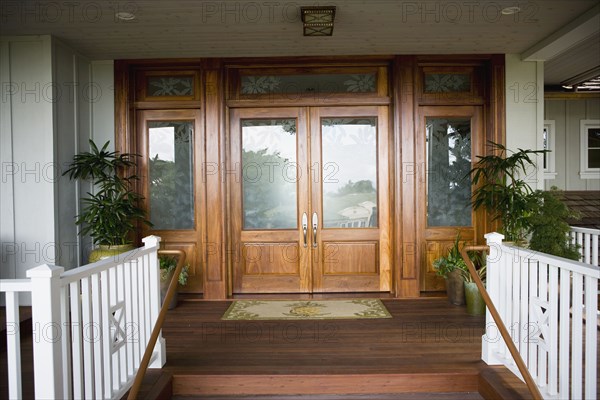 Floral glass paned front door with doormat