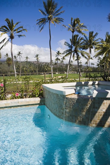 Outdoor hot tub pouring into swimming pool