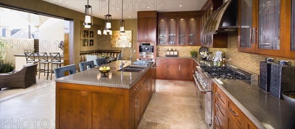 Contemporary kitchen with wall open to outside