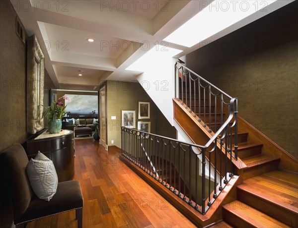 Modern hardwood staircase with wrought iron banister