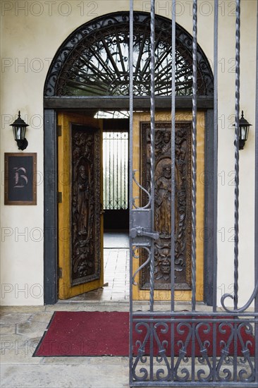 Wrought iron gate and hand carved wooden door