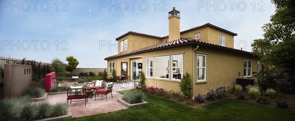 Contemporary patio behind Spanish style home