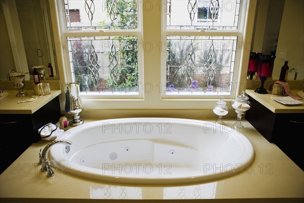 Contemporary hot tub beneath windows
