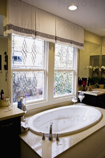 Contemporary hot tub beneath windows