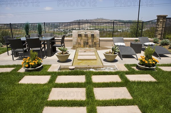 Back patio with contemporary fountain