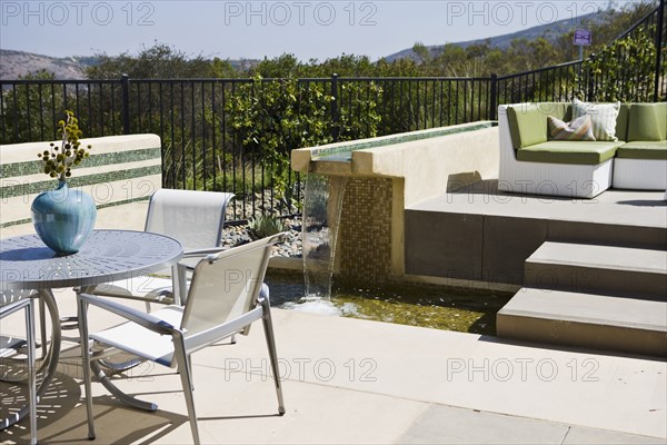 Contemporary fountain along patio