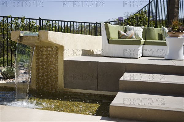 Contemporary fountain along patio