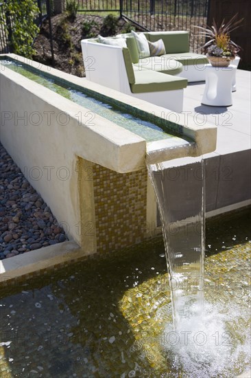 Contemporary fountain along patio