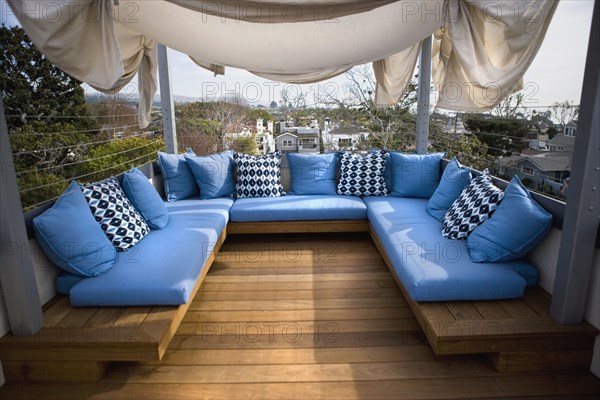 Rooftop sitting area with blue cushions