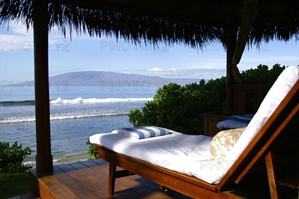 Lounge chair on deck overlooking ocean