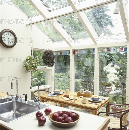 Apples in bowl in traditional kitchen with dining table