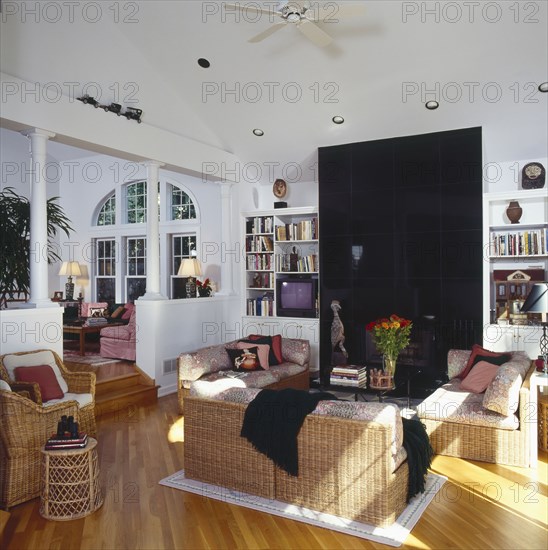 Woven furniture in traditional living room with high ceilings