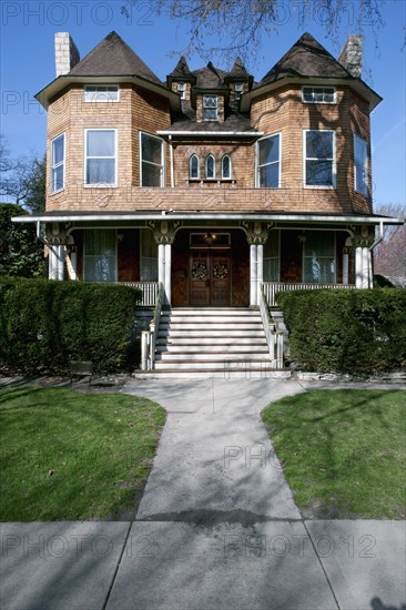 Facade of residential house with lawn in foreground