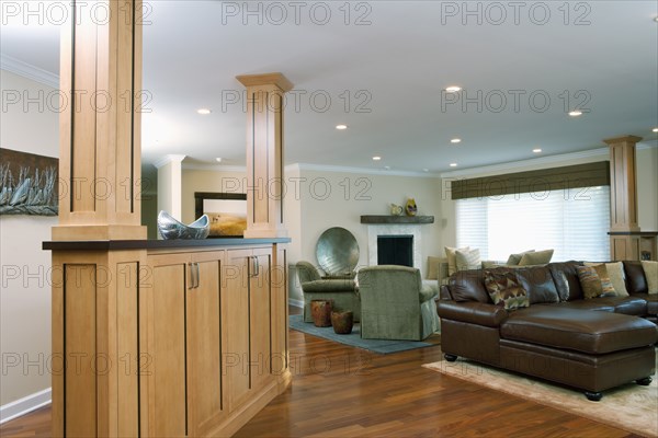 Interior of traditional living room with leather seating furniture and hardwood floor