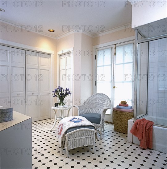 White wicker chair and ottoman with blue grey cushions