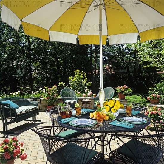 Close up of umbrella table and surrounding wicker furniture