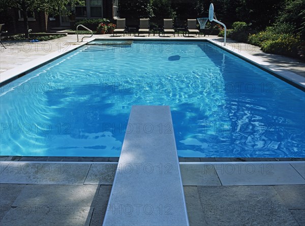 Straight on view looking from over the diving board toward the four lounge chairs