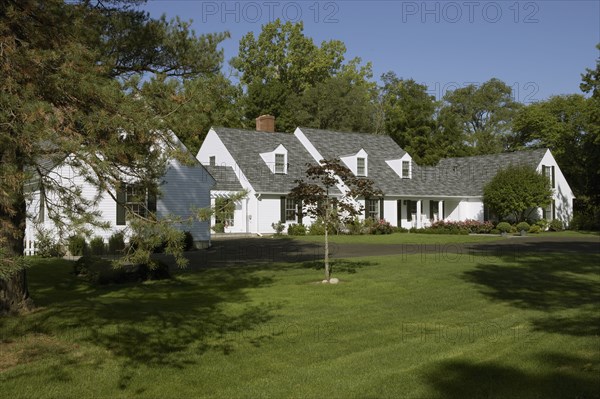 White traditional home with black shutters