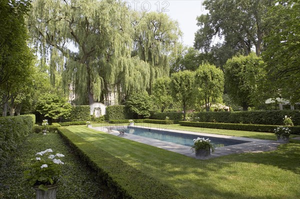 Formal shaped hedge garden with narrow pool
