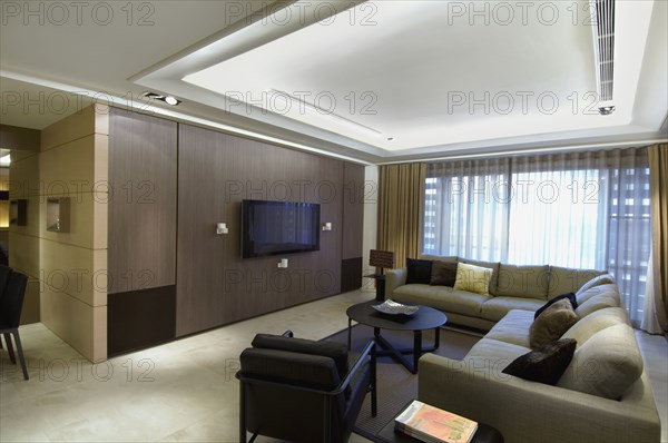 Contemporary living room with sectional sofa and flat screen television