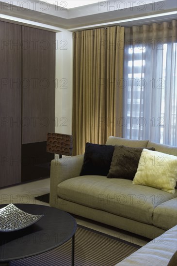 Detail contemporary sofa in front of window with drapes