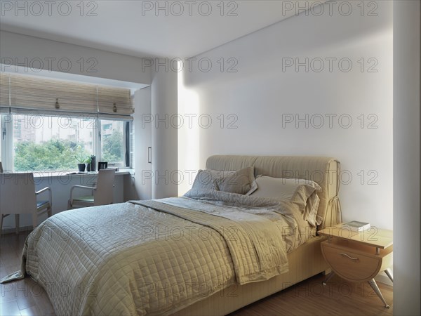 Contemporary bedroom with desk near window
