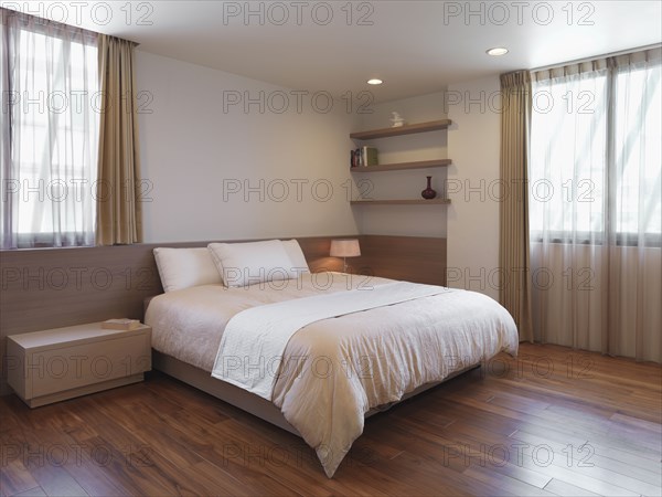 Simple minimalist bedroom with hardwood floors