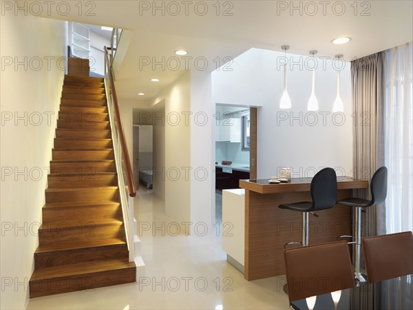 Interior of modern home with straight wooden staircase