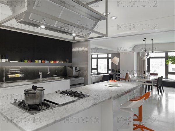 Modern Kitchen with orange and white bar stools