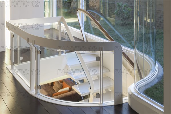 Modern white staircase with glass banister