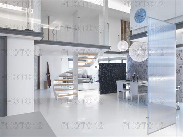 Modern dining area with winding staircase