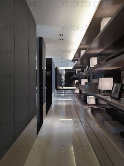 Hallway with marble floors and display shelves