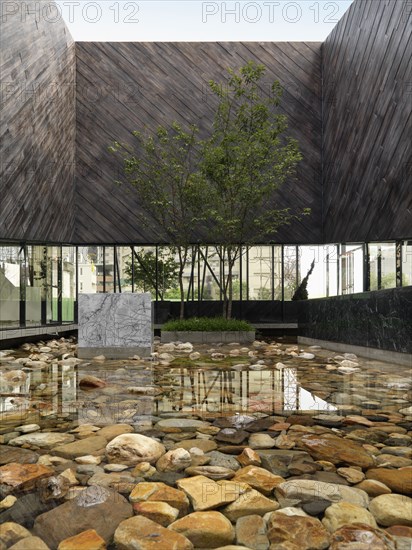 Rock pool surrounded by modern building