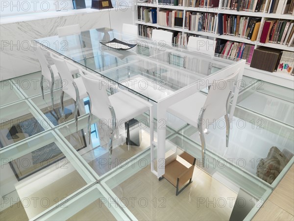 Glass conference table in room with glass floor